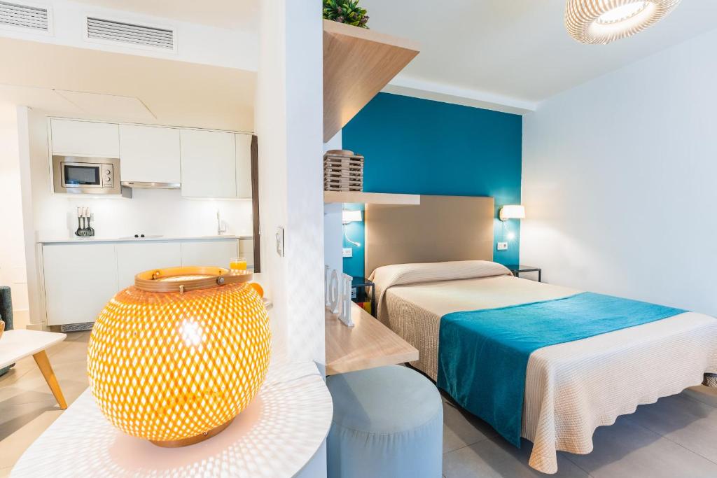 a hotel room with two beds and a kitchen at Debambú Larios in Málaga