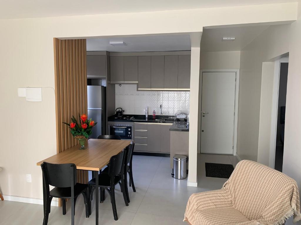 eine Küche und ein Esszimmer mit einem Tisch und Stühlen in der Unterkunft Apartamento 3100 in Balneário Camboriú