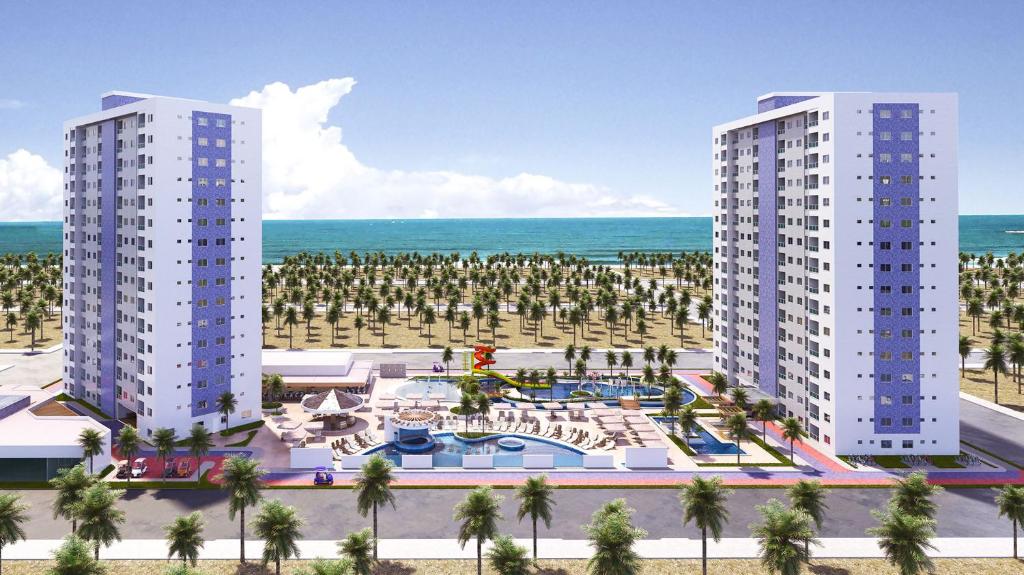two tall white buildings next to the ocean with palm trees at Apartamento em Salinas Exclusive Resort in Salinópolis