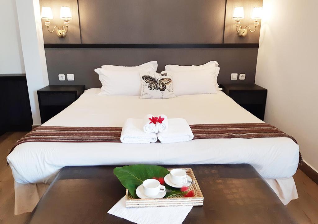 a hotel room with a bed with two towels at Hotel Purnama Lenggang in Gantung