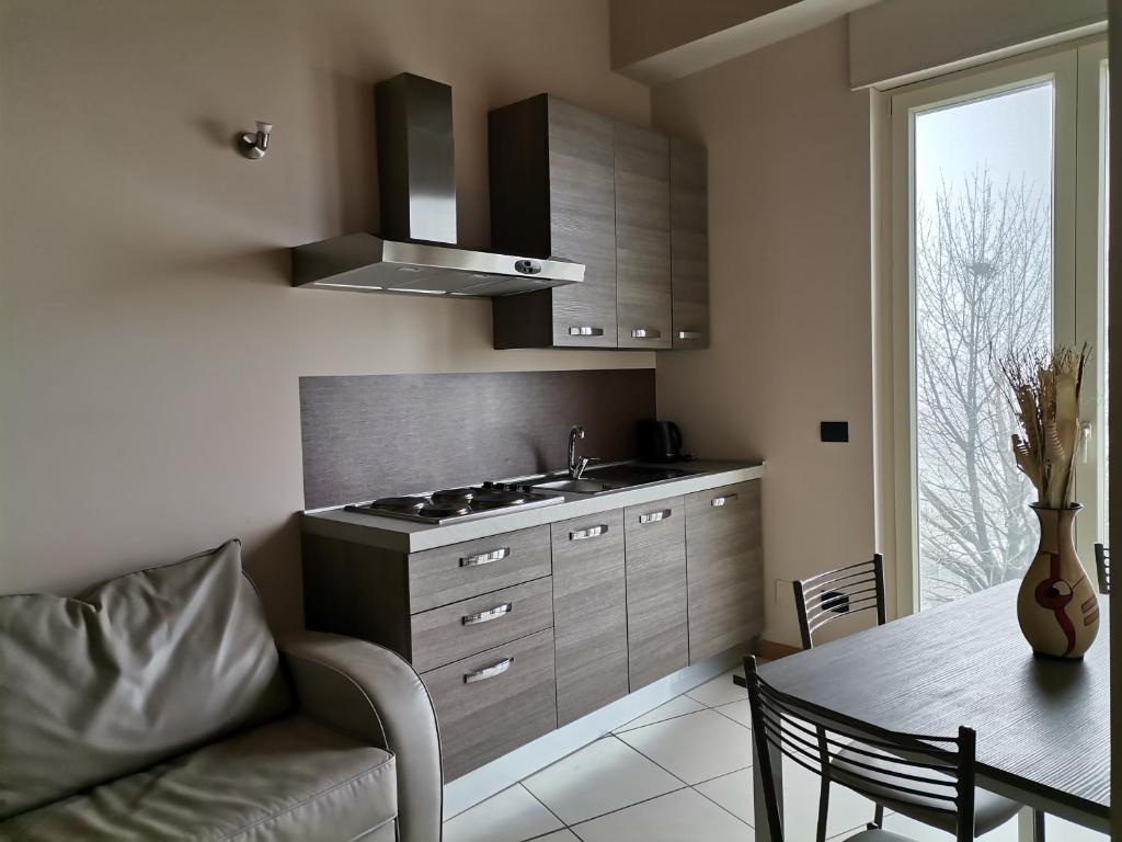 a kitchen with a couch and a table and a sink at Villa Cocuzza in Piozzo