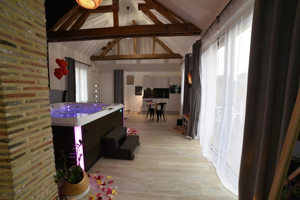 a large bathroom with a tub in a room at Eaudyssée maison avec SPA privée - Loiret in Ladon
