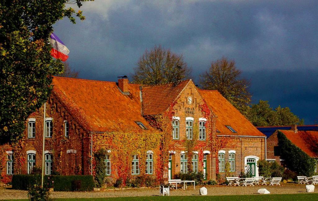 een groot bakstenen gebouw met een oranje dak bij Meierei 26 in Göhl
