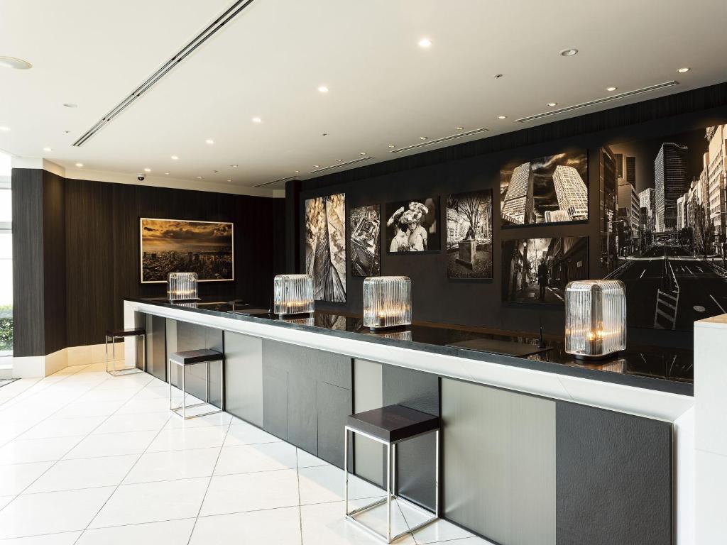 a bar in a hotel lobby with pictures on the wall at Shibuya Excel Hotel Tokyu in Tokyo