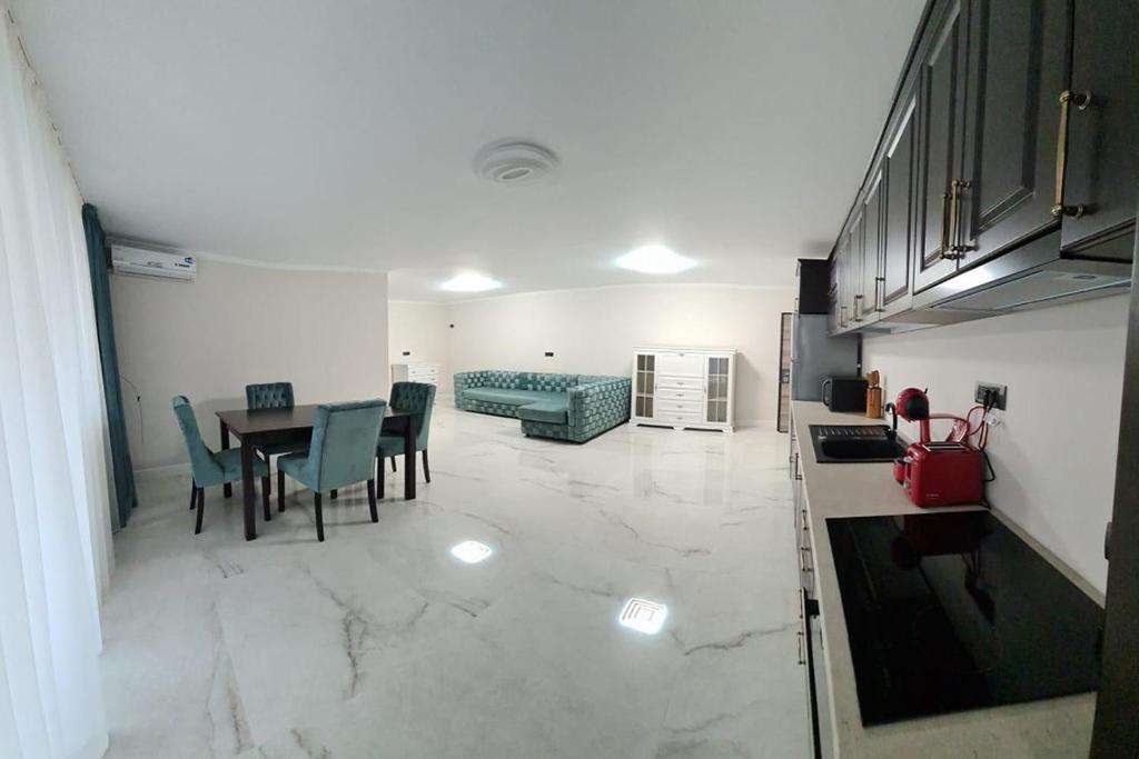 eine Küche und ein Esszimmer mit einem Tisch und einem Sofa in der Unterkunft MOKY REZIDENT in Arad