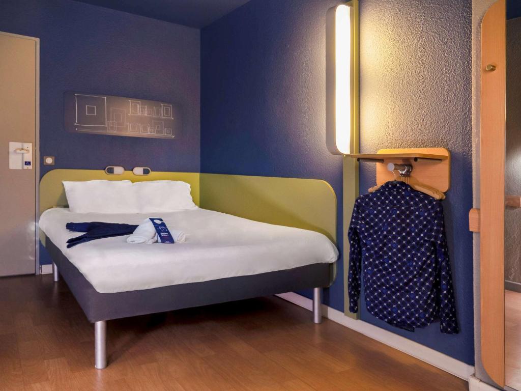 Postel nebo postele na pokoji v ubytování ibis budget Arles Sud Fourchon