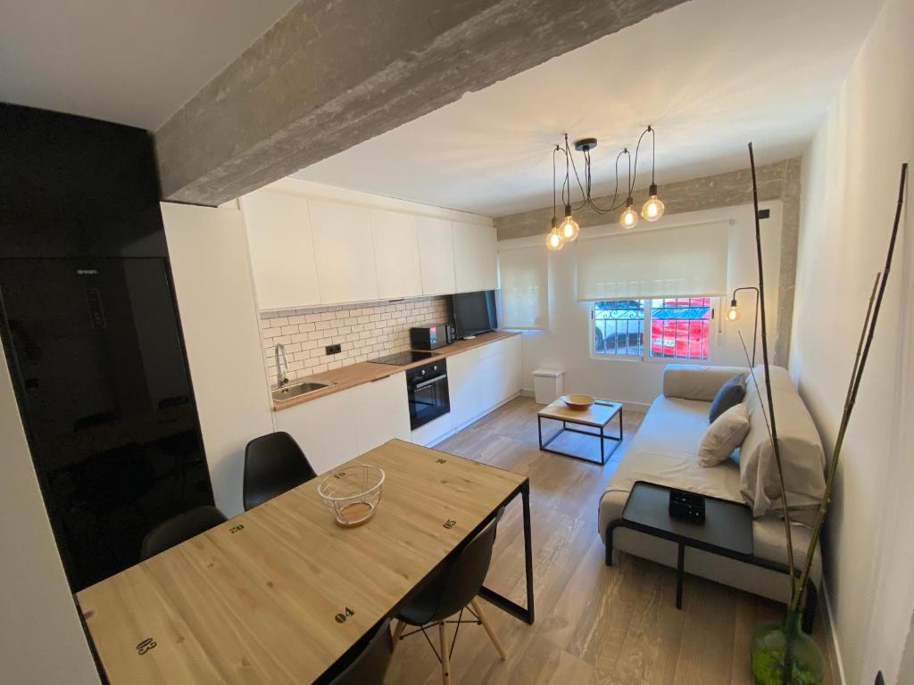 a living room with a couch and a table at Loft estilo industrial en playa de las marinas!!! in Denia