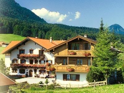a large house in the middle of a field at Oberaschenauer-Hof in Ruhpolding