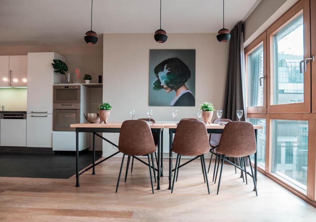 uma cozinha com uma mesa de jantar e cadeiras em Smartflats Design - L42 em Bruxelas