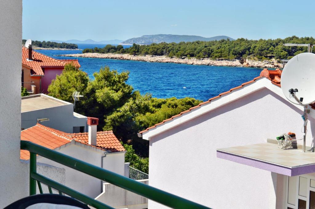 a view of the water from the balcony of a house at Apartment Toni 555 in Primošten