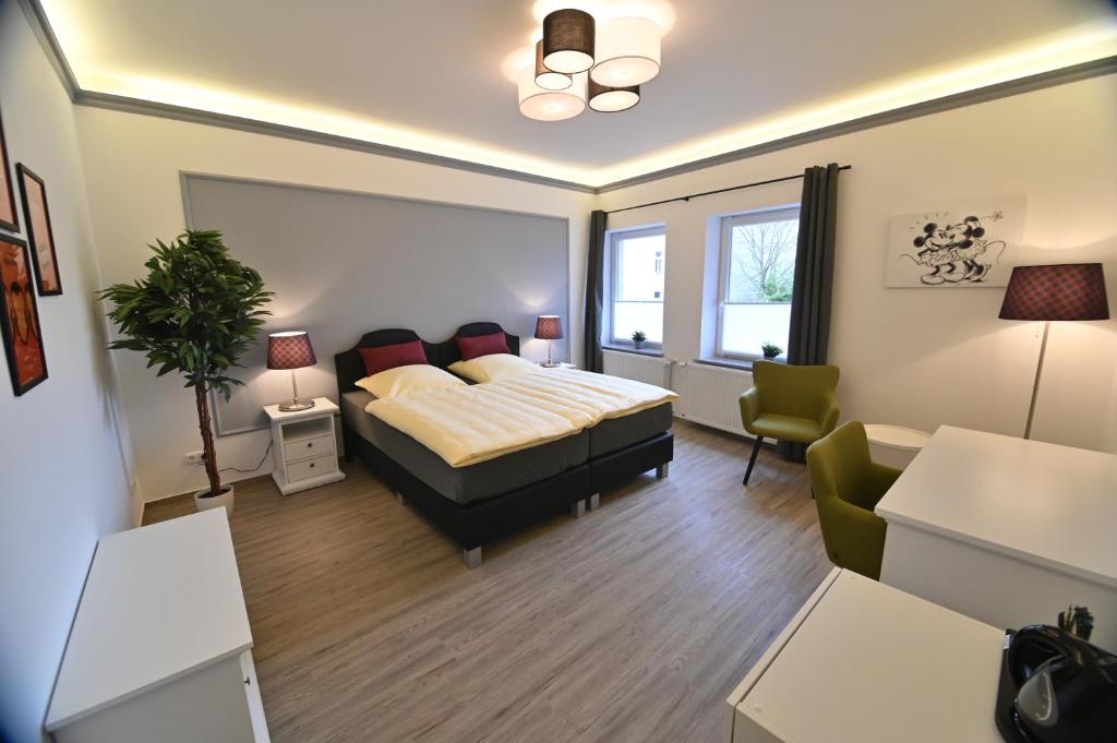 a bedroom with a bed and a living room at Pension am Schloss in Schwerin
