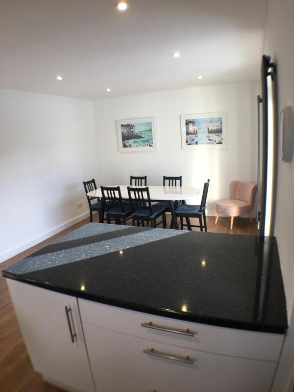 a kitchen and dining room with a table and chairs at Avocet House in Wells next the Sea