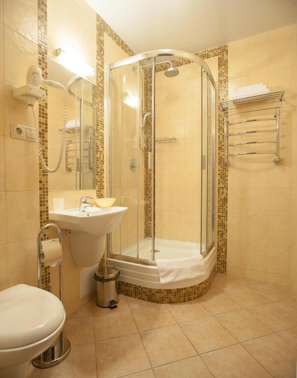 a bathroom with a shower and a toilet and a sink at Business Hotel Diplomat in Nizhny Novgorod