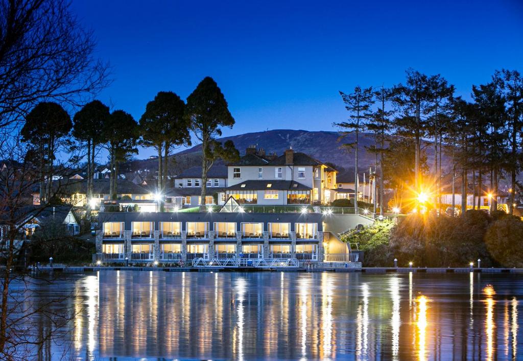 a large building on the water at night at The Lakeside Hotel & Leisure Centre in Killaloe
