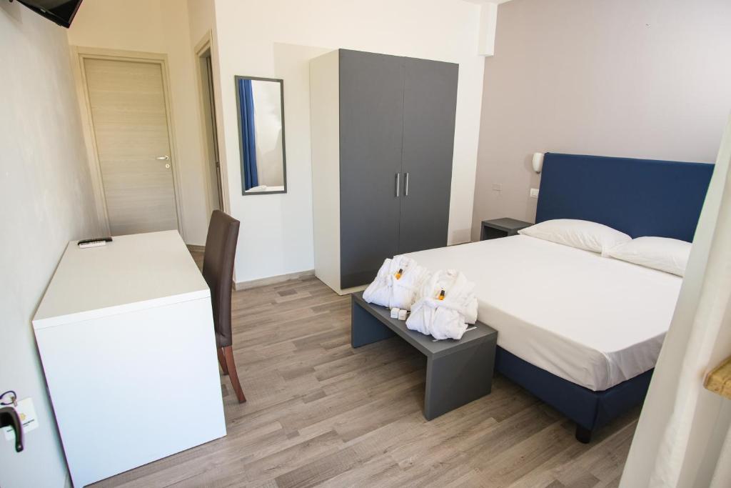 Postel nebo postele na pokoji v ubytování Torre Guaceto Greenblu Resort