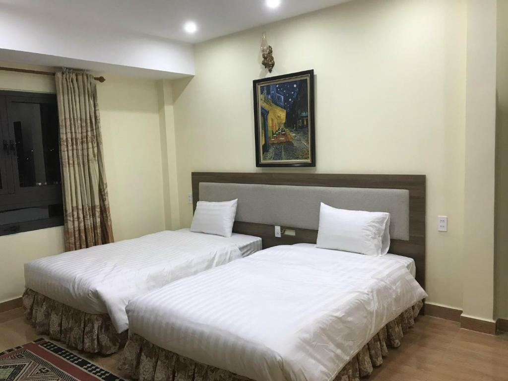 Postel nebo postele na pokoji v ubytování Ngoc Tran Hotel