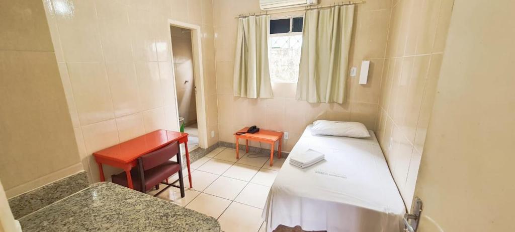 Ένα ή περισσότερα κρεβάτια σε δωμάτιο στο Hotel Metrópole