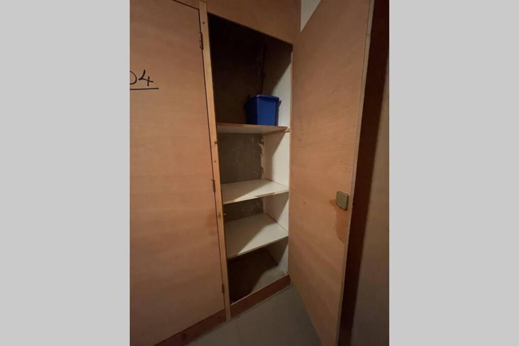 a room with a closet with shelves and a door at Studio neuf St Lary 10 min à pied in Vielle-Aure