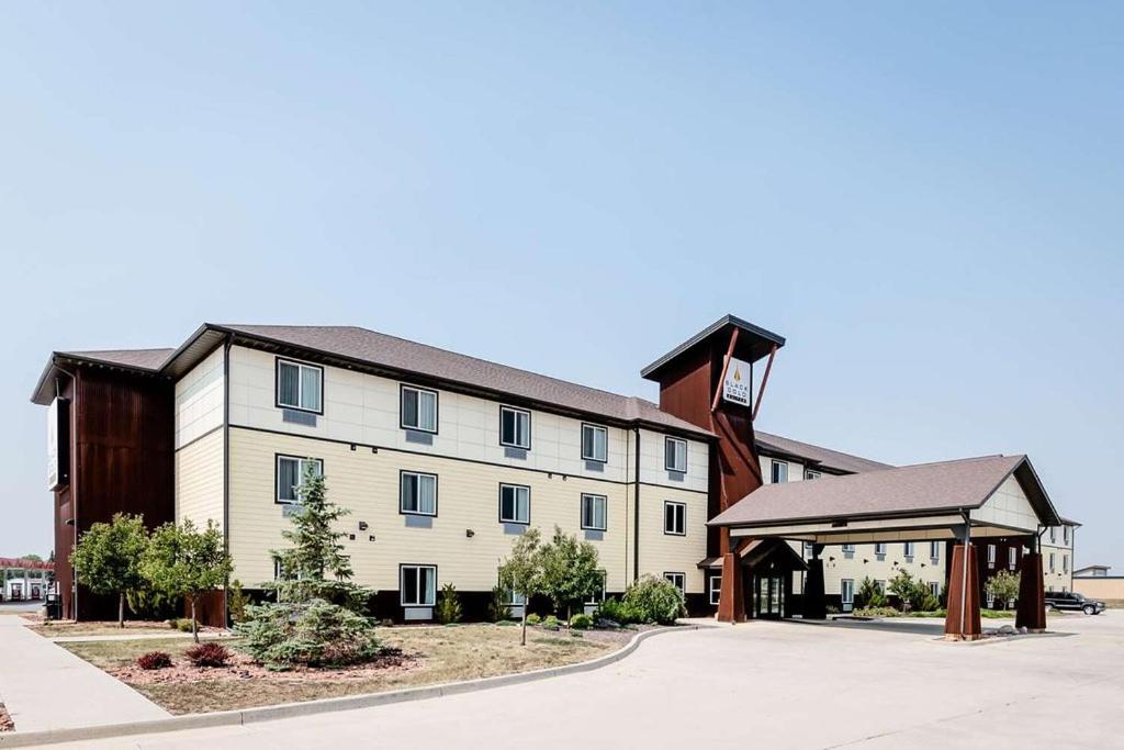 a large white building with a gazebo at Black Gold Suites in Tioga