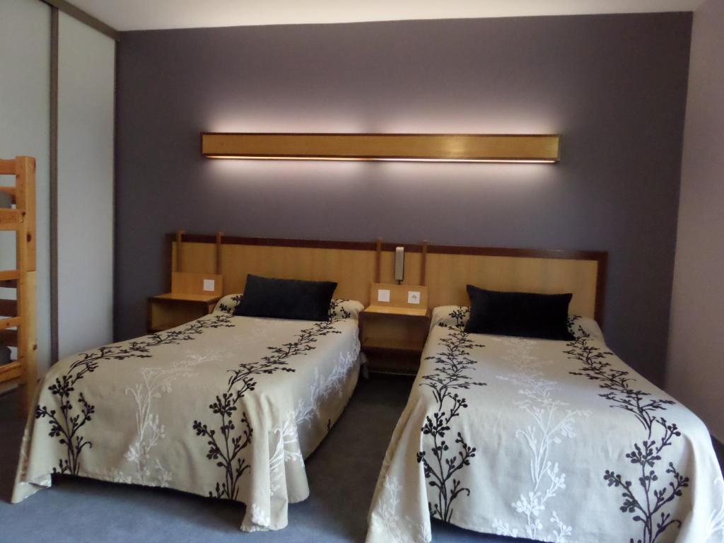 Postel nebo postele na pokoji v ubytování Hôtel le bastide