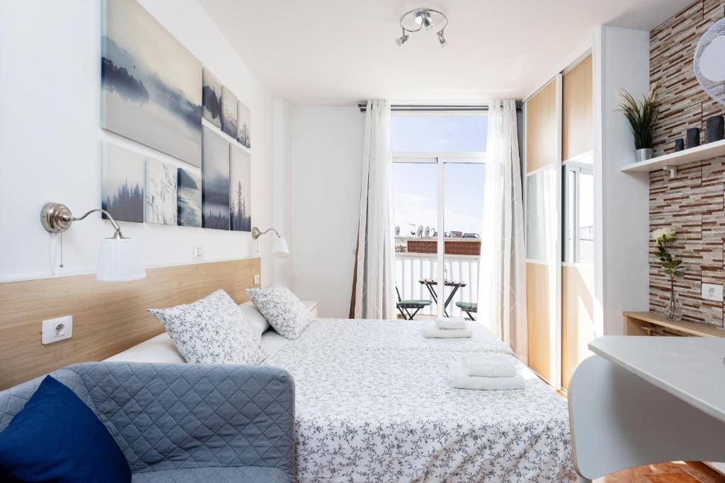 a small bedroom with a bed and a window at Apartamentos Ohana - Edificio Tonillo in Los Cristianos