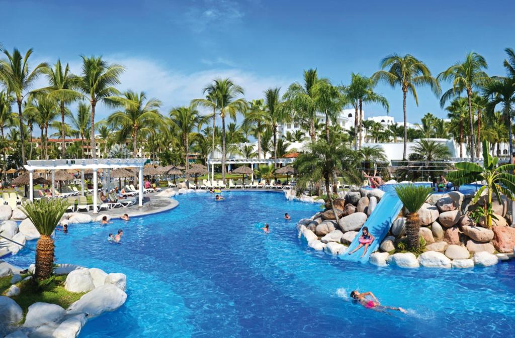 a pool at a resort with people in it at Riu Jalisco - All Inclusive in Nuevo Vallarta 