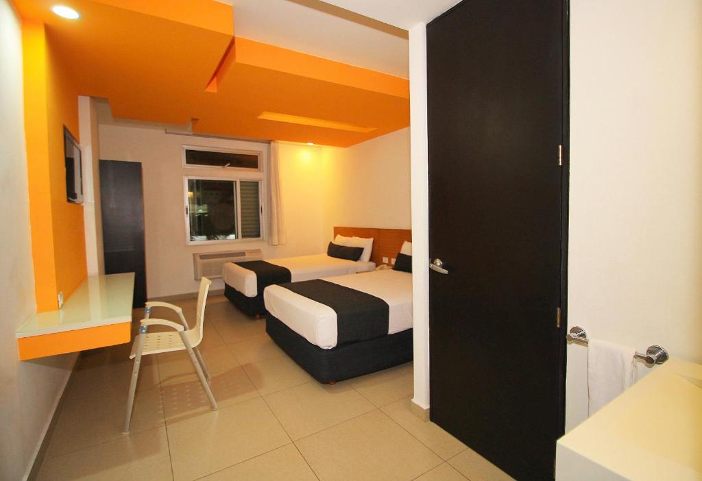 Postel nebo postele na pokoji v ubytování Nu Hotel