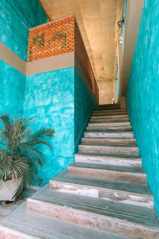 a stairway with blue walls and blue stairs at Distrito Hostel in Santa Marta