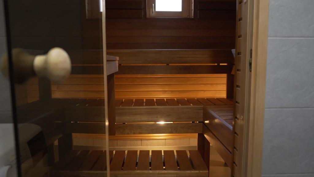 an empty room with wooden stairs with a window at SPLIFE plus in Kuru