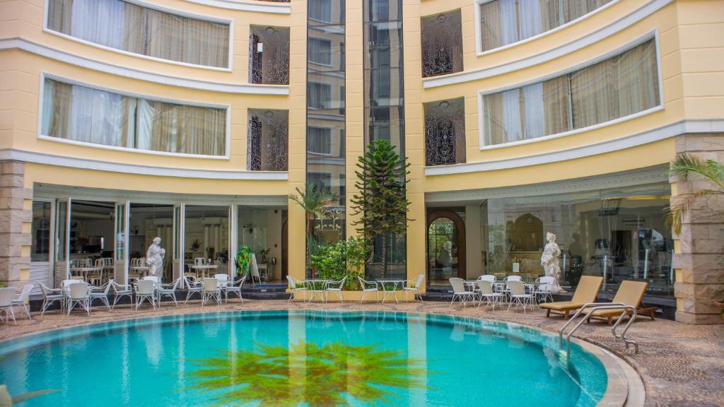 a hotel with a swimming pool in front of a building at Four Seasons Place Pattaya in Pattaya Central