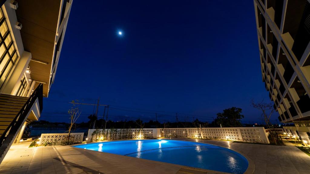 a swimming pool in the middle of a building at night at Hotel Torifito Miyakojima Resort in Miyako-jima