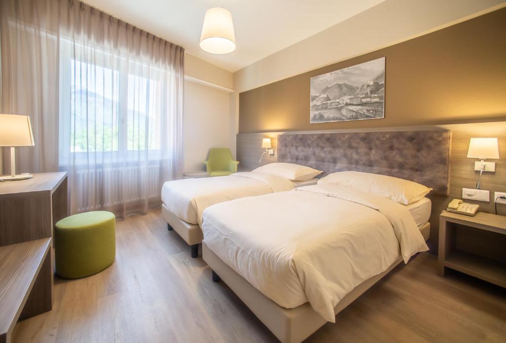 Postel nebo postele na pokoji v ubytování Hotel Unione