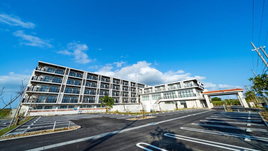 an empty parking lot in front of a building at Hotel Torifito Miyakojima Resort in Miyako-jima