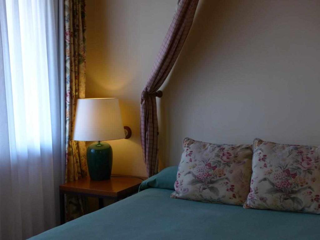 Postel nebo postele na pokoji v ubytování Hosteria del Arco