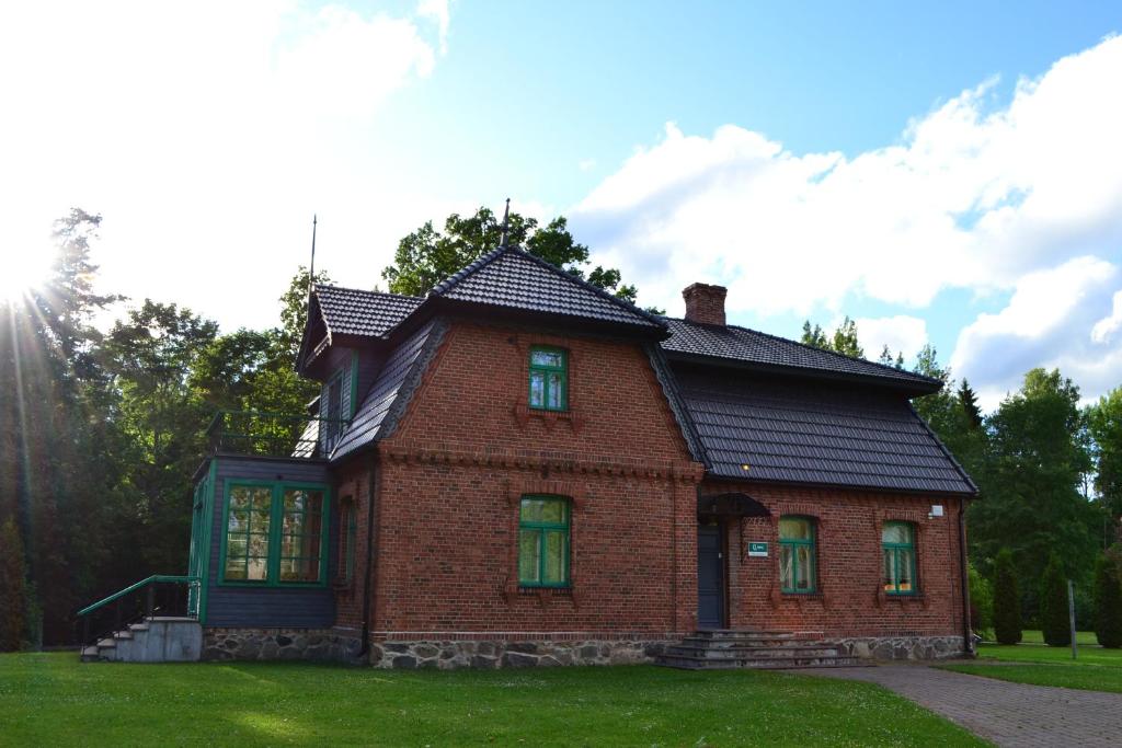 an old brick house with a black roof at RMK Lodja Jahimaja in Parnumaa