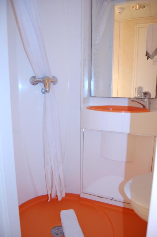 a bathroom with a shower, toilet and sink at easyHotel South Kensington in London