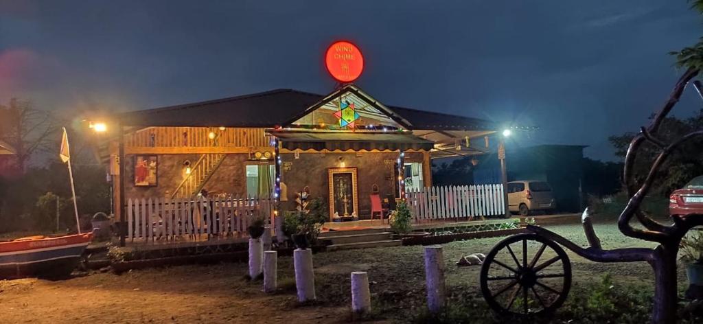 une petite maison avec un panneau en haut dans l'établissement Windchime Cottages, à Alibaug