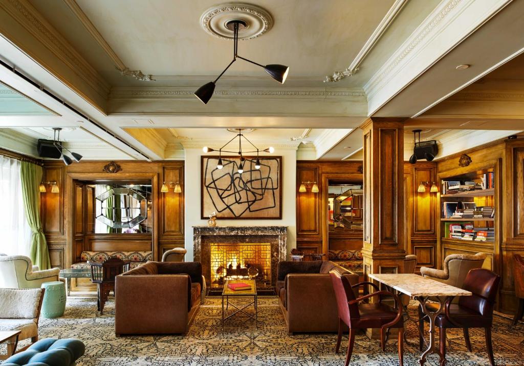 a large living room with a fireplace and furniture at The Marlton Hotel in New York