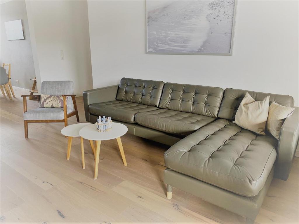 a living room with a couch and a table at Appartementanlage Wieben in Sankt Peter-Ording