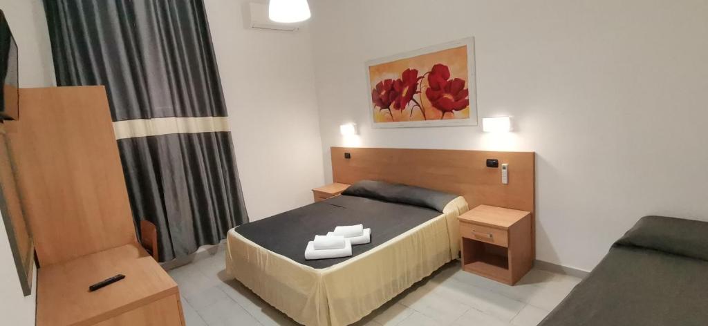 a small bedroom with a bed and a couch at Friendship Place in Rome