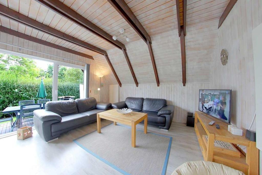 un soggiorno con un divano e un tavolo di SE Robbenplate 19 a Dorum-Neufeld