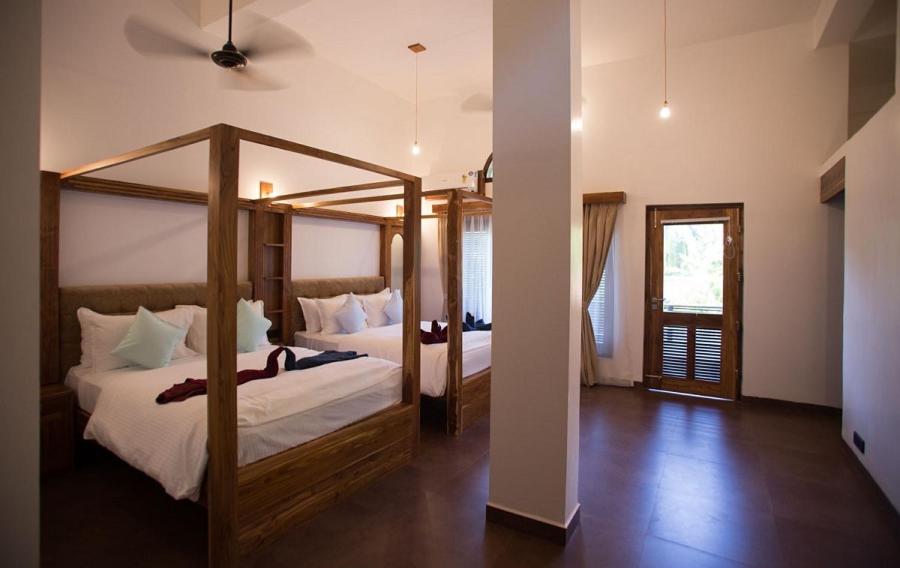 a bedroom with two bunk beds and a mirror at Dunhill Beach Resort in Agonda