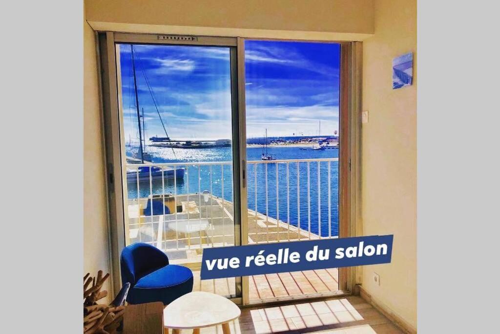 a room with a large window with a view of the water at LE PANORAMIQUE cap d’agde in Cap d'Agde