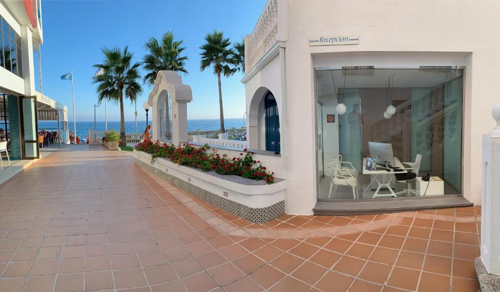 a hotel room with a balcony overlooking the ocean at Apartamentos Perla Marina in Nerja