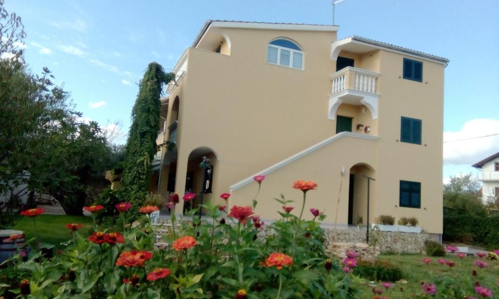 a house with flowers in front of it at Guest House Joso in Vodice