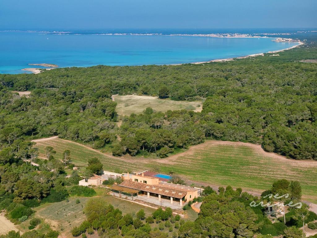 an aerial view of a house and the water at Agroturismo Ses Arenes in Colonia Sant Jordi