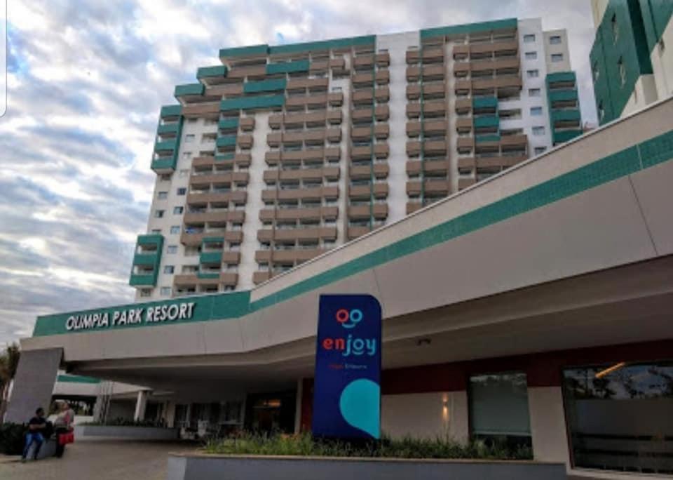 un grand immeuble d'appartements avec un panneau en face de celui-ci dans l'établissement Olímpia Park Resort Hotel, à Olímpia