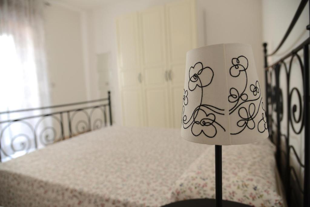 a bedroom with a bed with a lamp on it at Jonico Guest House in Scanzano