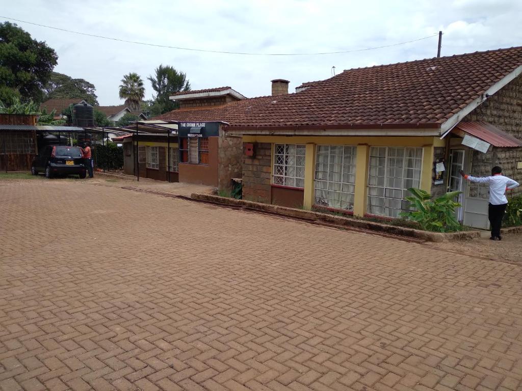 a man standing in front of a house at The Crown Place in Kericho