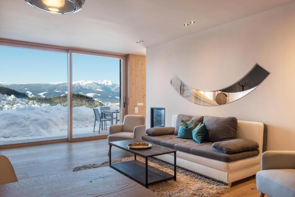 a living room with a couch and a table at Aura Chalets - Nr 4 in Castelrotto